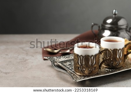 Tea served in vintage tea set on grey table, space for text
