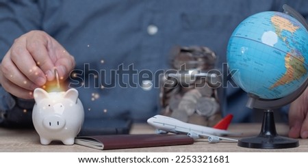 man putting money into piggy bank concept of saving money. wealth and financial concept, Business, finance plan, investment, travel, plane, passport, holiday, vacation.