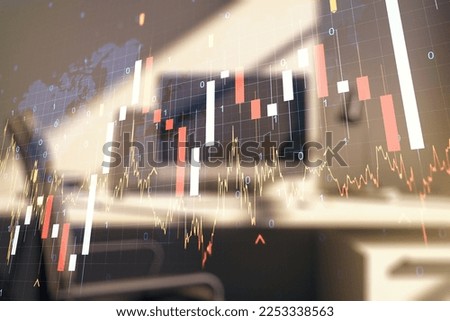 Abstract creative financial graph with world map and modern desktop with computer on background, forex and investment concept. Multiexposure