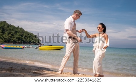 Romantic moments in Valentine day At the beautiful beach and sea.Man and Women in beautiful white dresses On beach.Day of Love and Marriage concept