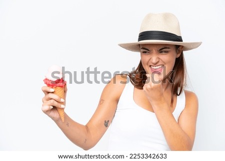 Young caucasian woman with a cornet ice cream isolated on white background celebrating a victory