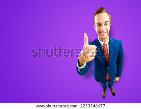 Full body businessman in blue suit showing thumb up like agree hand sign gesture on violet purple background. Comic look happy man. Cartoon style character with big head. Funny face. Copy space mockup