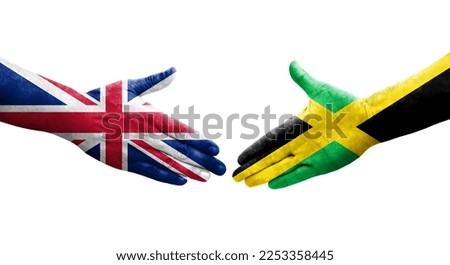 Handshake between Jamaica and United Kingdom flags painted on hands, isolated transparent image.