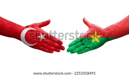 Handshake between Burkina Faso and Turkey flags painted on hands, isolated transparent image.