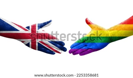 Handshake between LGBT and United Kingdom flags painted on hands, isolated transparent image.