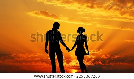 Image of the evening sun and people standing and holding hands