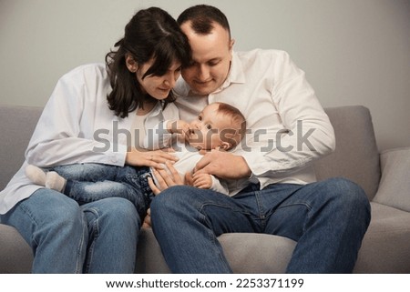 Portrait of young happy parents with a small child
