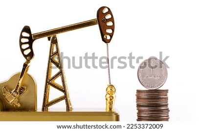Gold oil pump and 1 United Arab Emirates dirham coin