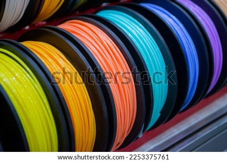 Many multi-colored spools of thread of filament for printing 3d printer. Material coils for printing 3D printer. Spools of 3D printing motley different colors filament. ABS wire plastic for 3d printer Royalty-Free Stock Photo #2253375761