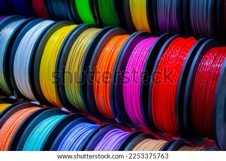 Many multi-colored spools of thread of filament for printing 3d printer. Material coils for printing 3D printer. Spools of 3D printing motley different colors filament. ABS wire plastic for 3d printer Royalty-Free Stock Photo #2253375763
