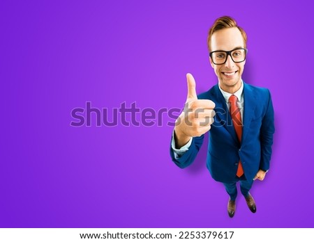 Full body businessman in eye glasses, blue suit show thumb up like, agree hand sign gesture, purple background. Comic cartoon style funny man in eyeglasses, big head. Funny face. Expert recommending.