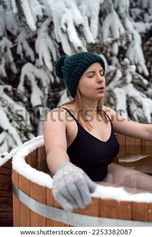 Caucasian woman during the winter bath in tube outdoors Royalty-Free Stock Photo #2253382087