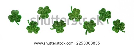 Happy St. Patrick's Day banner.Holiday background.St Patricks Day frame against a white background. Flat lay shamrocks.Copy space.Patrik's day banner Royalty-Free Stock Photo #2253383835