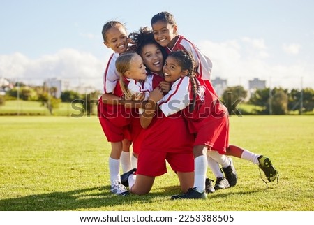 Soccer children, winner or happy for success, goal or wellness in match, game or fitness with smile on football field. Motivation, sport or kids celebrating in training, workout for teamwork exercise Royalty-Free Stock Photo #2253388505