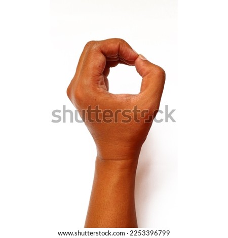 Hand of asian man with brown skin in gesturing pose                             