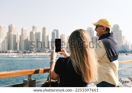 Happy middle aged couple taking picture Jumeirah beach frontline