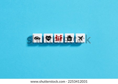 White blocks with insurance icons on blue background. Family, life, car, travel, health and house insurance.