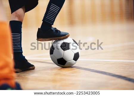 Football futsal player, ball, futsal floor. Indoor soccer sports hall. School boys on indoor football training session Royalty-Free Stock Photo #2253423005