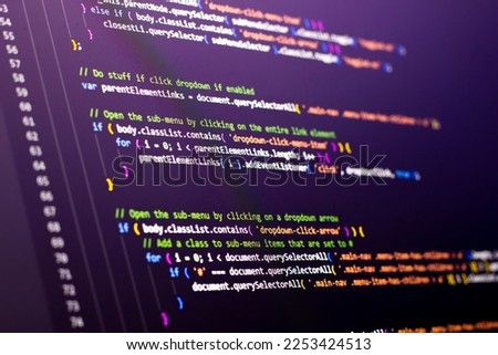 The software developer is doing javascript coding. Abstract code background. Selective focus code on computer screen
