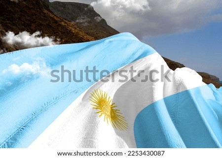 Argentina national flag cloth fabric waving on beautiful mountain background.