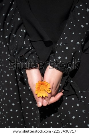 Picture of sunflower in the hands of a young woman with sunlight in the garden