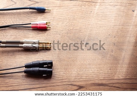 Stereo cables, Stereo connections. XLR balanced, phone jack, Stereo phone plug and stereo pin jack connector on a rustic wooden table. 