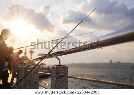 Fishing tackle, fishermen and fishing rods in the sea. Royalty-Free Stock Photo #2253442003