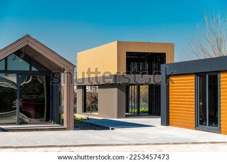 Newly built metal framed building with siding. Construction of a new tiny house. selective focus Royalty-Free Stock Photo #2253457473