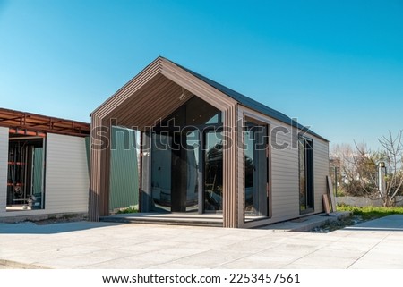 Newly built metal framed building with siding. Construction of a new tiny house. selective focus Royalty-Free Stock Photo #2253457561