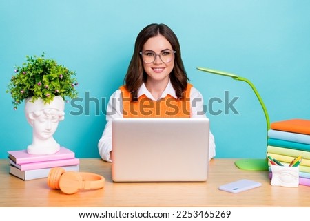 Photo of pretty positive lady wear stylish clothes use modern device work from home preparing exam isolated on cyan color background