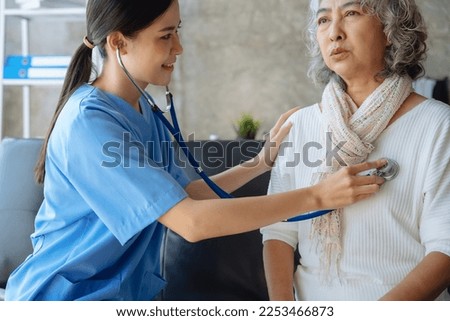 Doctor with stethoscope examining elderly patient with examination, healthcare and medical concept.