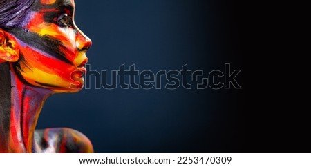 Portrait of the beautiful girl with art colorful make-up and bodyart. Download a picture with free space for text. Mockup for a music album. Cover design for e-book. Abstract image