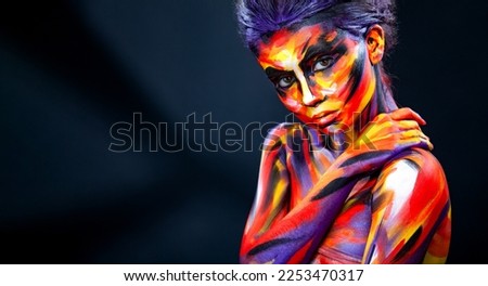 Portrait of the bright beautiful girl with art colorful make-up and bodyart. Download a picture with free space for text. Mockup for a music album. Cover design for e-book. Abstract image