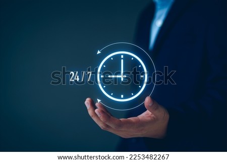 nonstop service concept. businessman show virtual 24-7 with clock for worldwide nonstop and full-time available contact of customer service concept. digital online customer service on internet network Royalty-Free Stock Photo #2253482267
