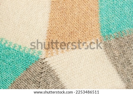 Knitted wool loops background. Soft colorful knitted fabric texture