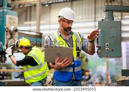 Portrait Caucasian professional Engineer factory. Engineering working with team and digital tablet computer in safety hardhat at factory industrial facilities. Heavy Industry Manufacturing Factory Royalty-Free Stock Photo #2253495015