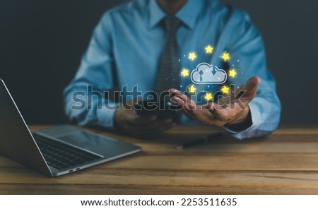 Creative background, A man hand with the iPad, the image of the hologram of the cloud, blue background. The concept of cloud technology, cloud storage, and a new generation of networks. Mixed media.