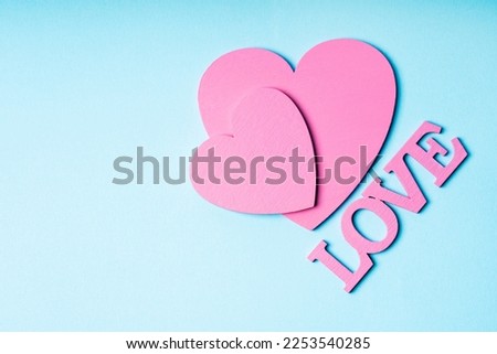 Valentine's Day. Paper hearts on a pastel background. Abstract background with paper-cut shapes. Saint Valentine
