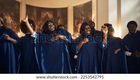 Black Christian Gospel Singers in Church Clapping and Stomping, Praising Lord Jesus Christ. Warm Atmosphere in Church Thanks to Energetic Choir Singing Uplifting Music with Emotions and Happiness Royalty-Free Stock Photo #2253542791