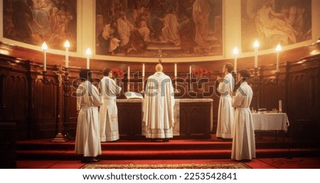 In Grand Old Church at the Altar Ministers Lead The Eucharist, a Sacred Christian Ceremony. Holy Communion, Divine Mass, Lord's Supper. Community Sharing Wisdom and Guidance of the Bible Royalty-Free Stock Photo #2253542841