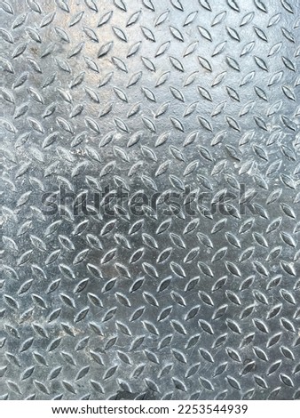 Rusty steel plate texture and background. Old grungy metal floor seamless of steel sheet metallic. It's silver with rhombus shapes for design art work, backdrop or skin product.