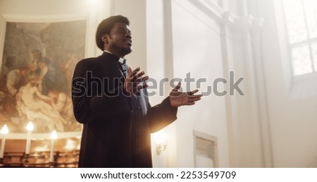 Service In Christian Church: Minister Leads Congregation In Prayer, Quotes The Bible, Gospel and Teaching of Jesus Christ. Priest Doing Sermon that Gives Hope. Beautiful Moment in Sacred Place Royalty-Free Stock Photo #2253549709