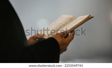 In Christian Church: Close Up of The Bible, Gospel of Jesus. Minister Leads The Congregation In Prayer and Reads From The Holy Book, Priest Providing Guidance, Belief, Hope to People. Royalty-Free Stock Photo #2253549741