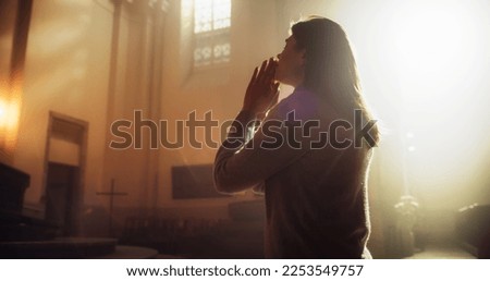 Side View: Christian Woman Getting on her Knees in Front of Altar and Starting to Pray in Church. Devoted Parishioner Seeks Guidance From Faith and Spirituality. Religious Believer in Power of God Royalty-Free Stock Photo #2253549757