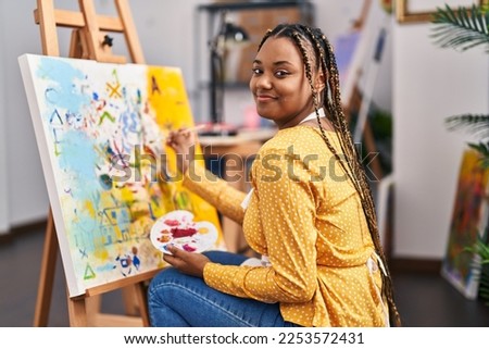 African american woman artist smiling confident drawing at art studio Royalty-Free Stock Photo #2253572431