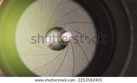 Front detail of camera lens iris blades smoothly opening