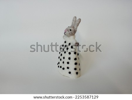 Easter Bunny or rabbit made of felt on white background from the side