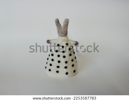 Easter Bunny or rabbit made of felt on white background from back