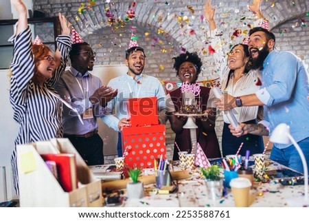 Businesspeople celebrating their colleagues birthday in office Royalty-Free Stock Photo #2253588761