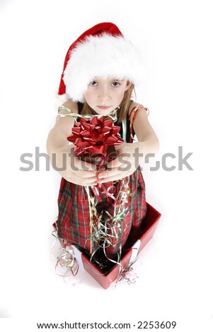 A young girl giving a gift box with a red bow, she is coming out of a gift box